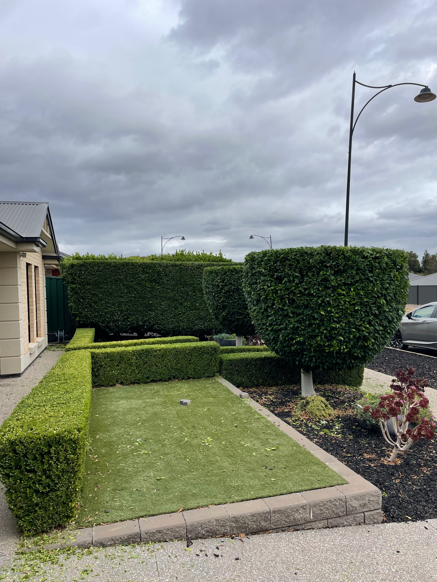 Immaculately shaped formal hedges and topiary in a front garden